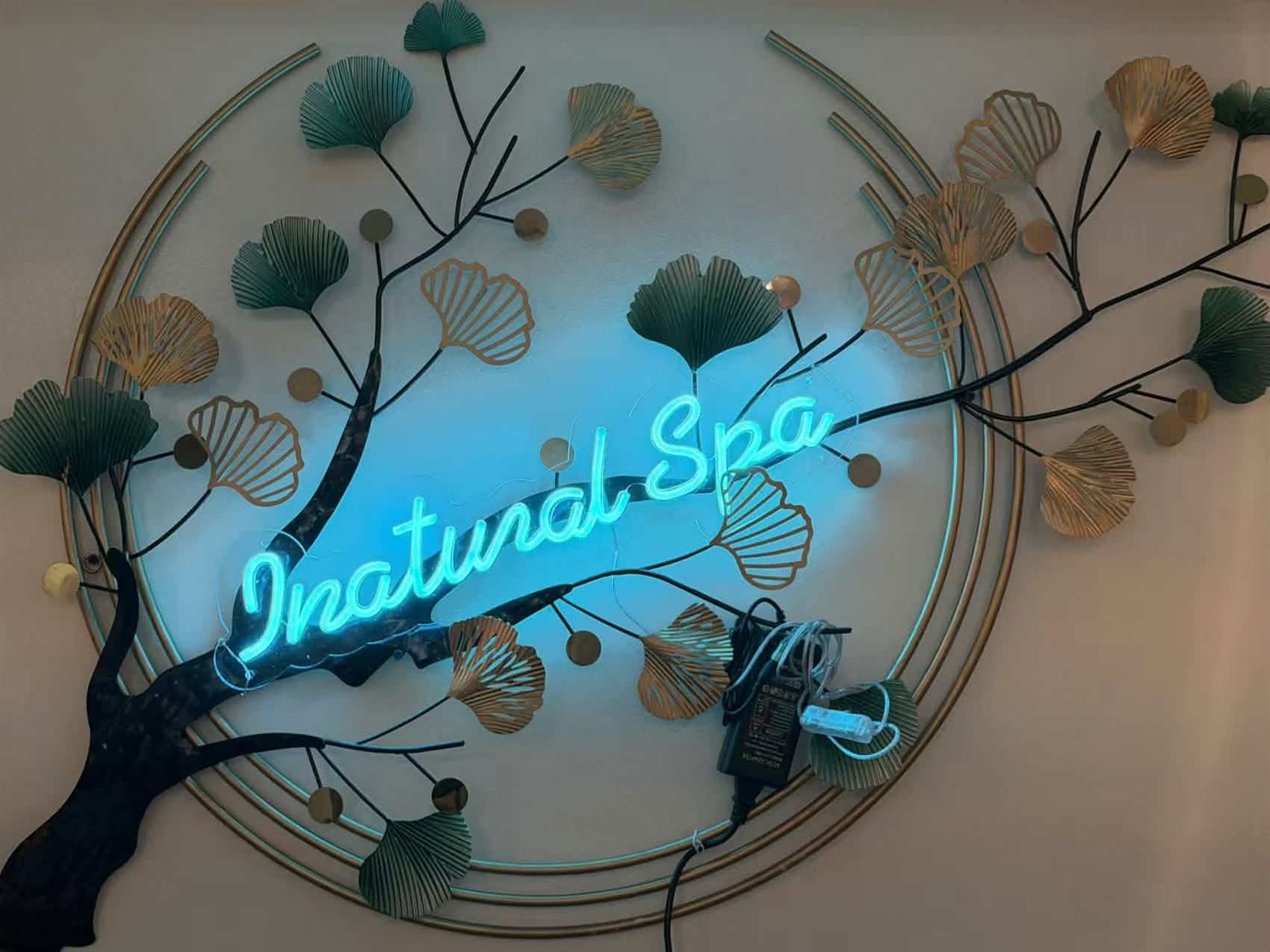 INatural Spa neon sign on the ginkgo tree wall art inside the spa